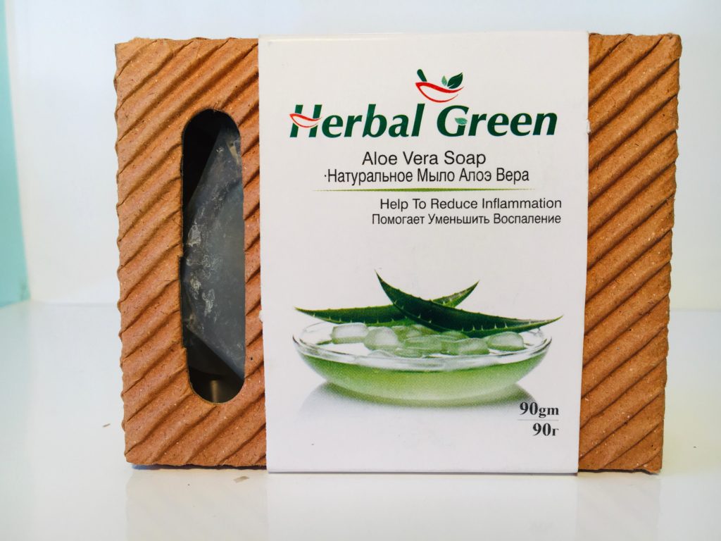 Herbal Green Aloe Vera Soap bar, shown with fresh aloe leaves and gel.